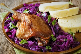 Roast duck leg with red cabbage and dumplings. Photo: iStock / ALLEKO